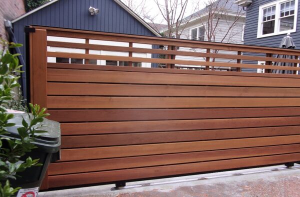 Residential Wood Gate Slides On V-Track Controlled By Transmitters And Wireless Keypad