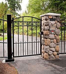Pedestrian Gate Mounted to River Rock Column
