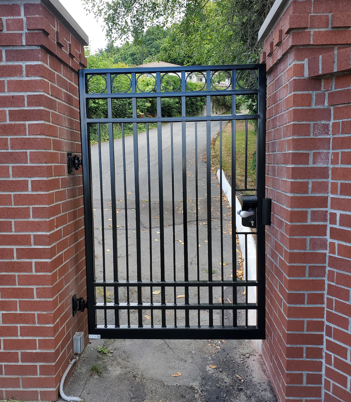 A Locked Pedestrian Gate Creates A Secure Walkway For Visitors Entering A Property On Foot
