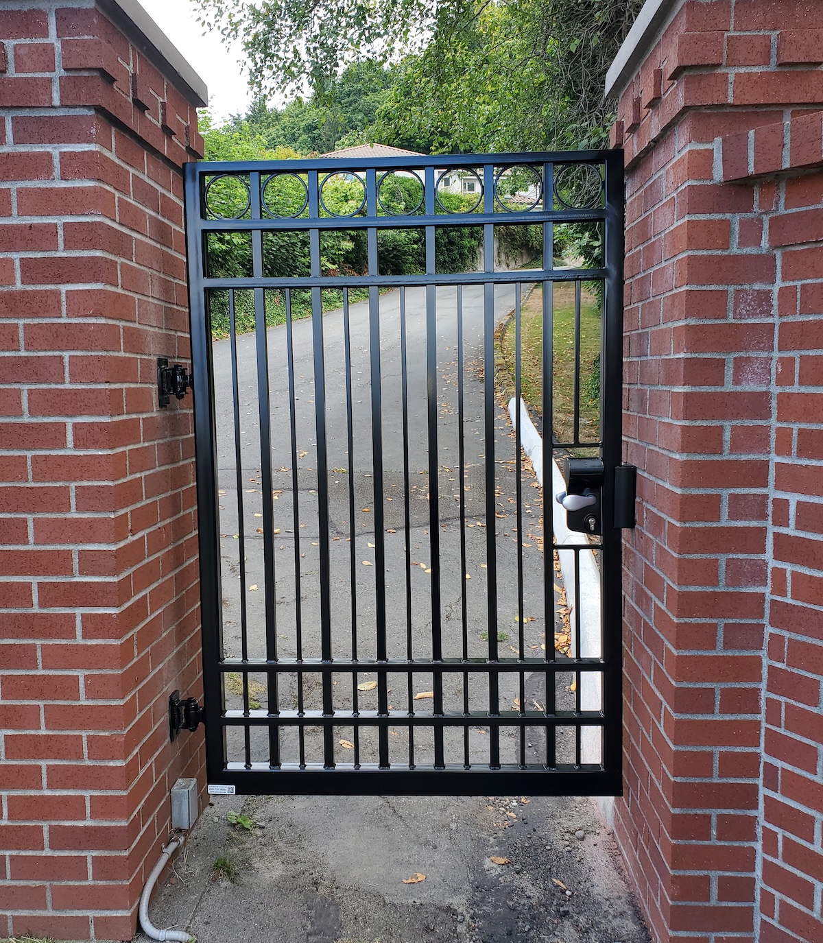 Locked Pedestrian Gate A Locked Pedestrian Gate Creates A Secure Walkway For Visitors Entering A Property On Foot