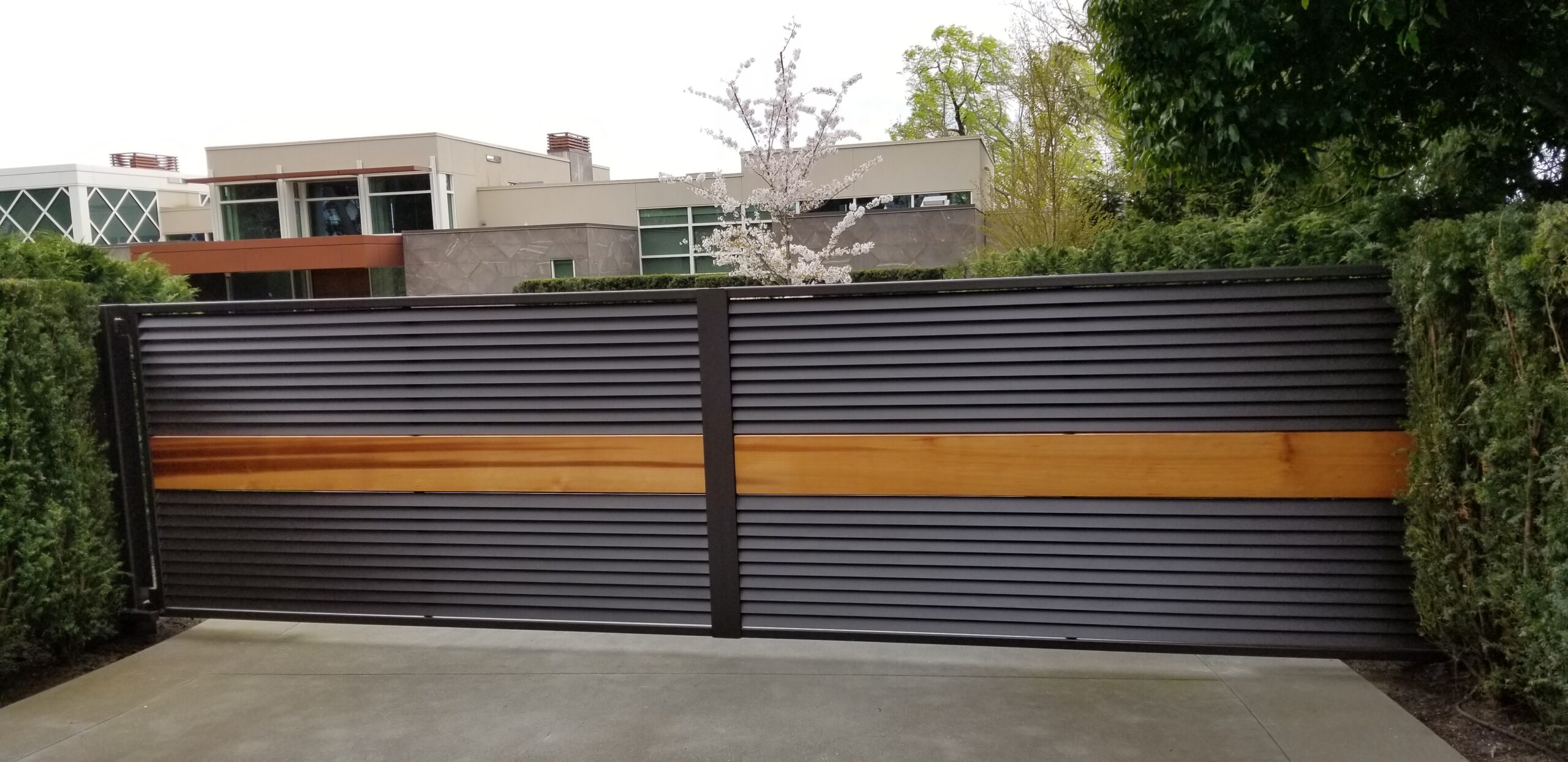 Louvered Iron And Cedar Double Swing Gate Provides Beauty, Privacy, And Security