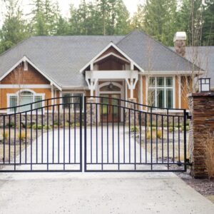 Custom Residential Driveway Gate With Stacked Stone Pillars And Flattop Fencing