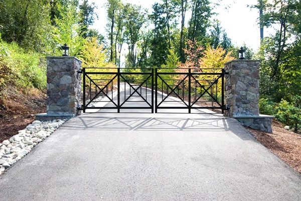Residential Swing Gate Iron swing gate with geometric shapes on a sloped driveway in Sammamish.