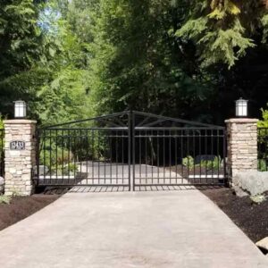 Closed, automated steel driveway gate.