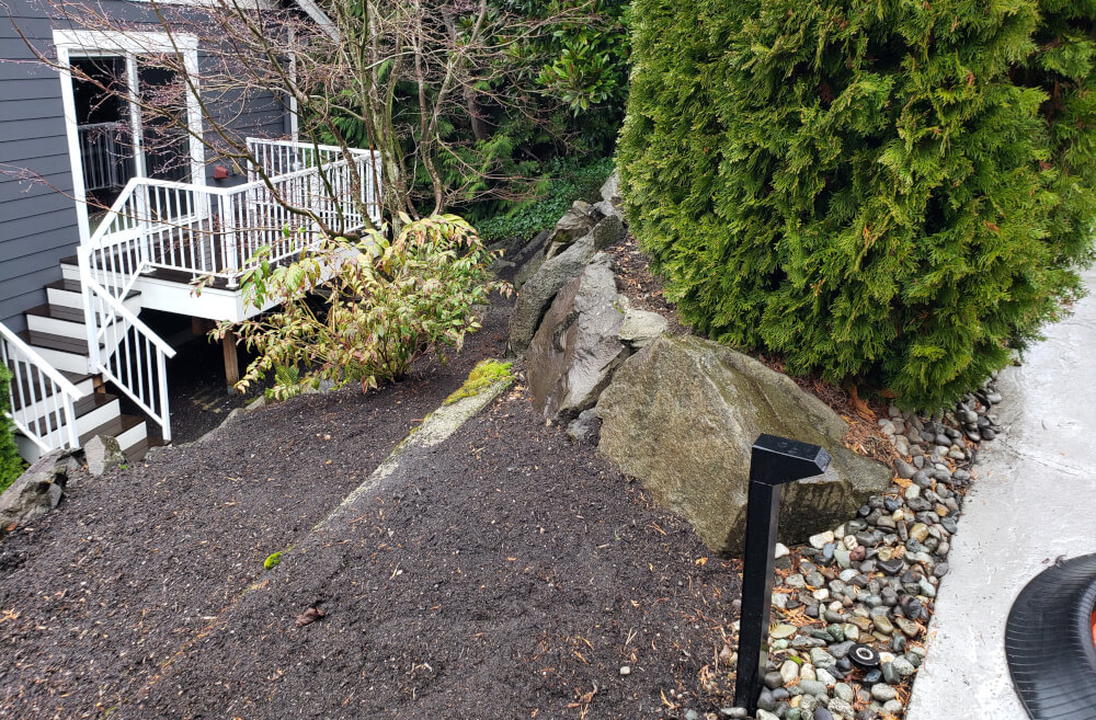 Driveway gate next to a very steep drop-off.